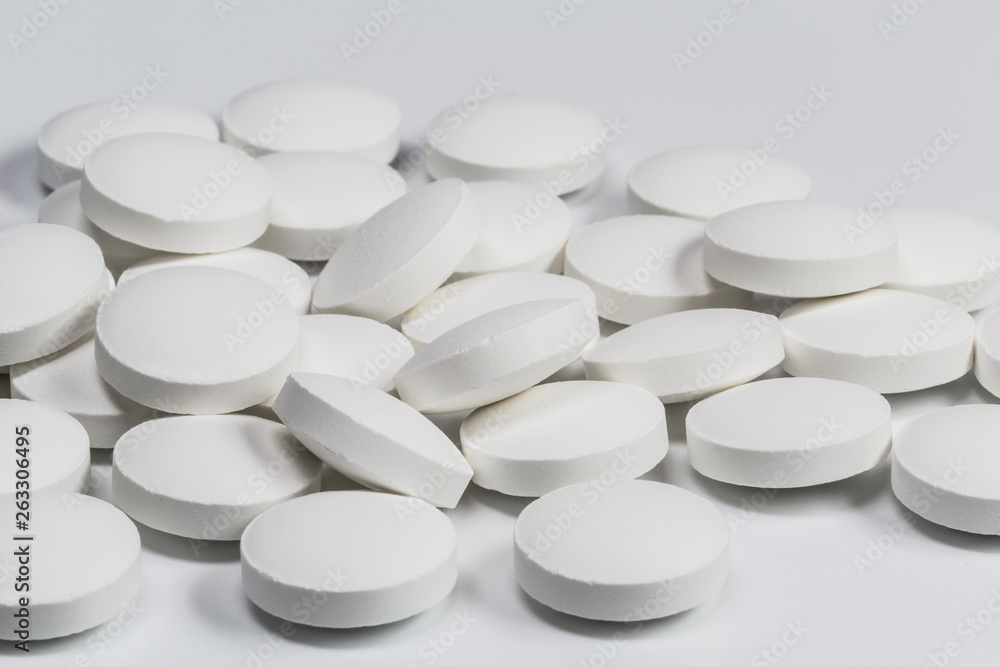 White pills on white background White pills on white background