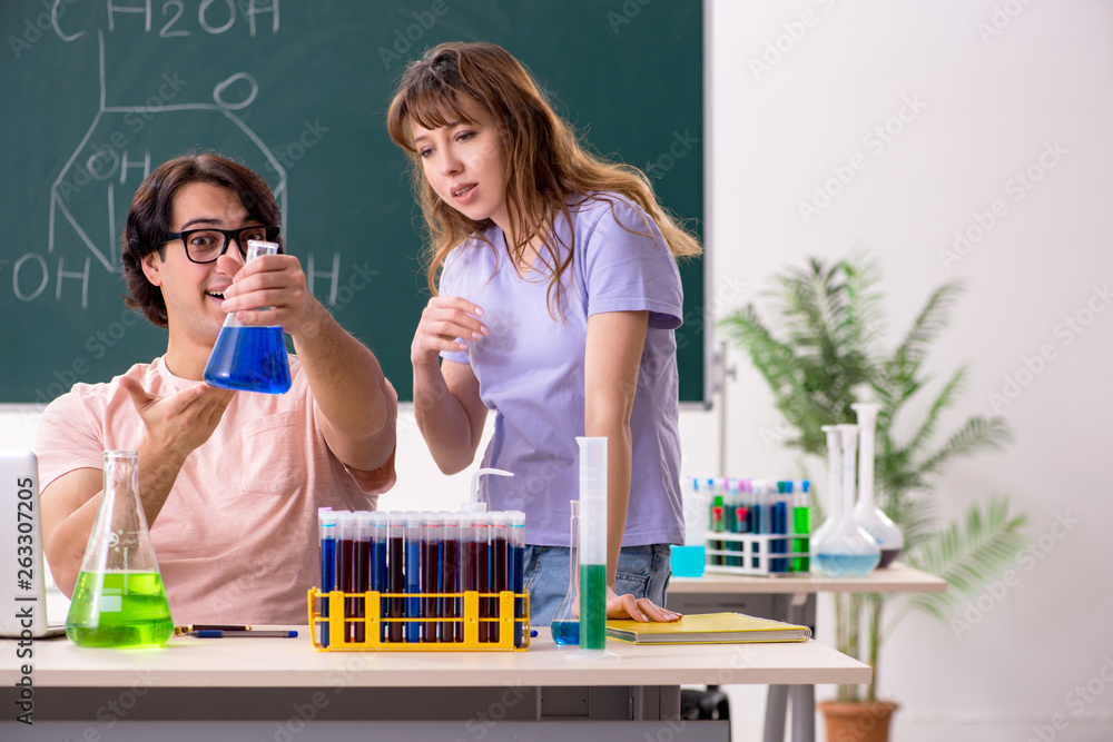 Two chemists students in classroom Two chemists students in classroom