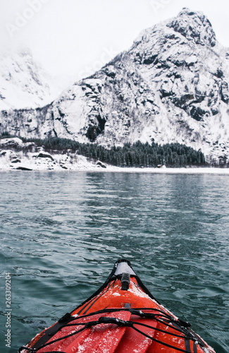 Winter Kayaking Along Coast of Lofoten Archipelago in the Arctic Circle in Norway
