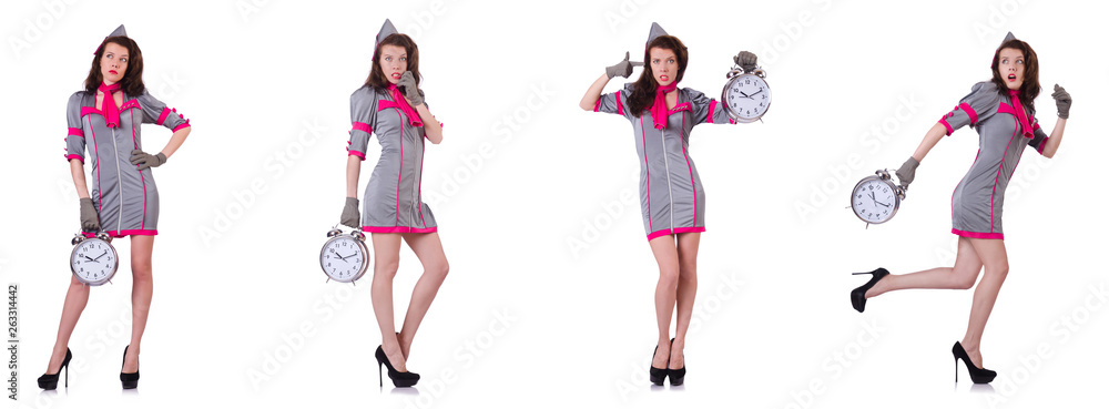 Young stewardess with alarm-clock in time management concept Young stewardess with alarm-clock in time management concept