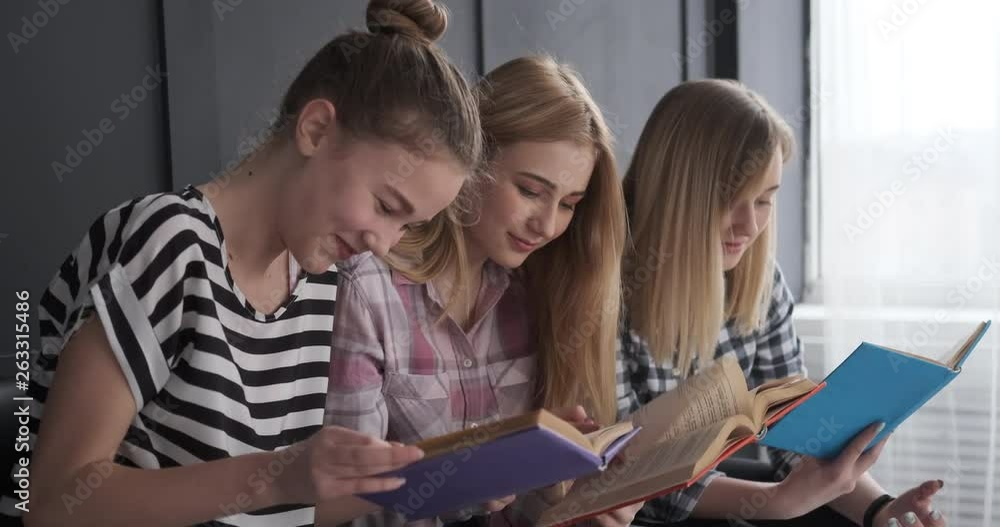 Joyful teenage girls reading books Joyful teenage girls reading books