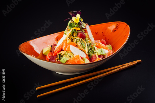 Salad with surimi, avocado, salmon and tuna.