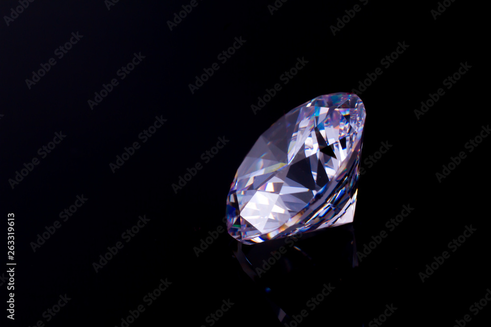 Elegant chic crystal on a black mirror surface with a reflection of a diamond Elegant chic crystal on a black mirror surface with a reflection of a diamond