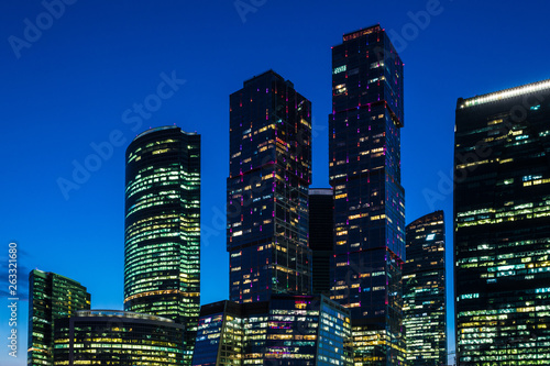 The windows of the unique skyscrapers of Moscow city, the modern office center in Moscow in the evening in the rays of setting sun on the bank of Moskva river