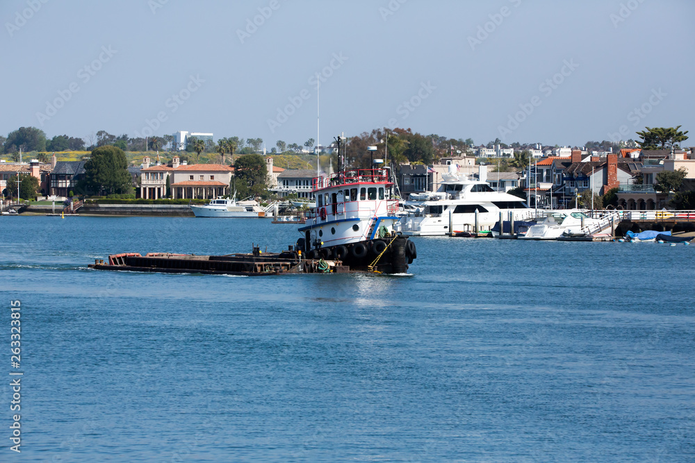 Tugboat moves through the water of the bay