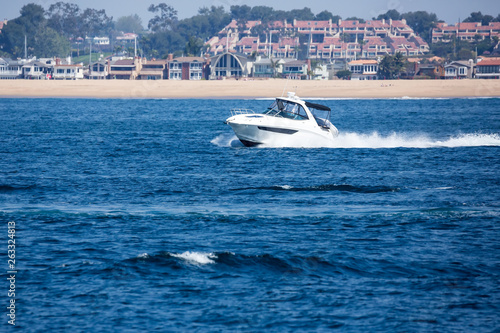 Speedboat cuts through the water of the bay © ecummings00