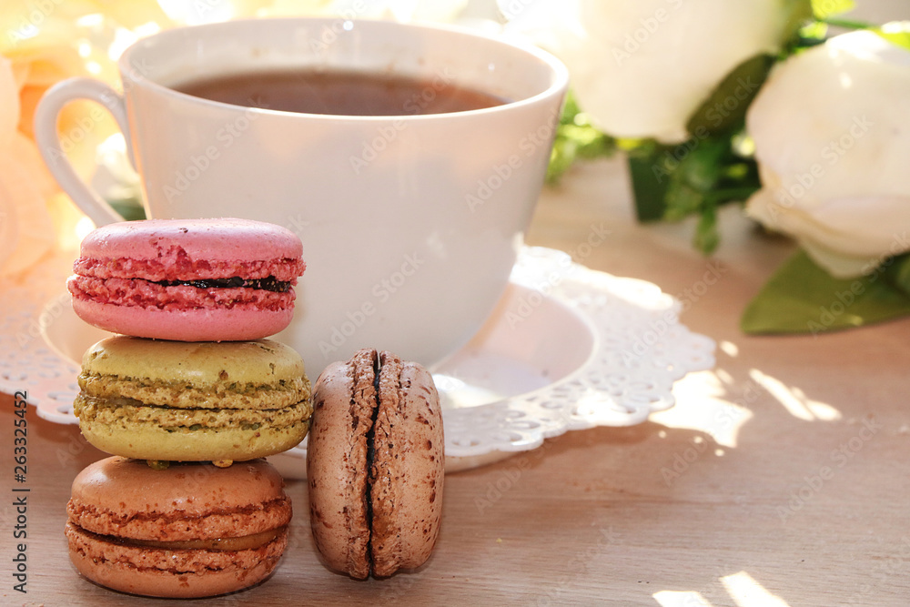 Fresh macaroons with tea on a light background. Extremely shallow depth of field with selective focus in the foreground. Fresh macaroons with tea on a light background. Extremely shallow depth of field with selective focus in the foreground.
