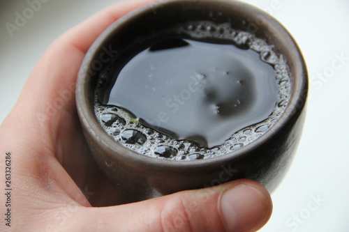hand holding a ceramic tea cup