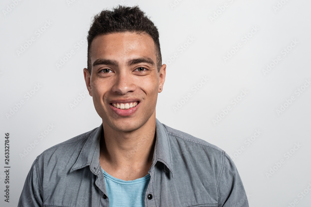 Closeup portrait of a cheerful man posing in the studio against the white background Closeup portrait of a cheerful man posing in the studio against the white background