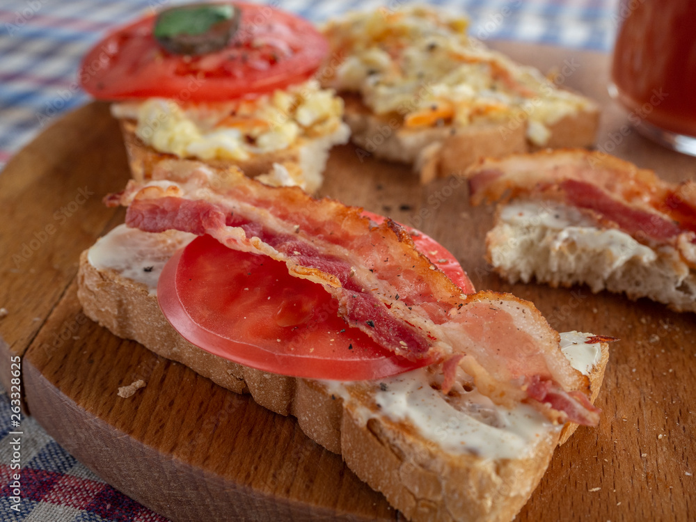 Bacon sandwich, fried tomato and tomato juice.Cowboy style Bacon sandwich, fried tomato and tomato juice.Cowboy style