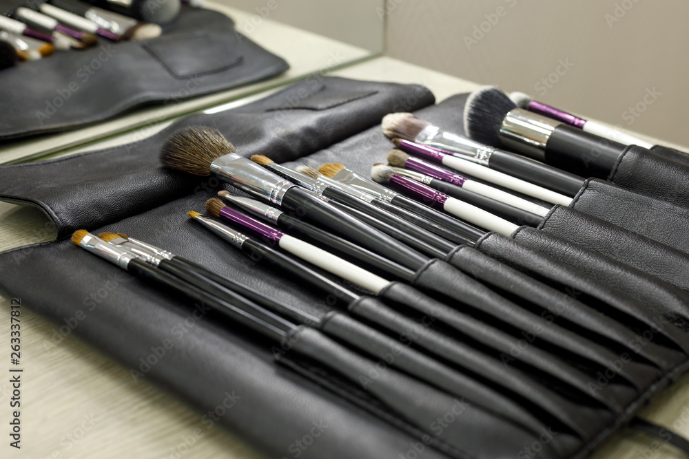 Set of cosmetic brushes in a black leather case Set of cosmetic brushes in a black leather case