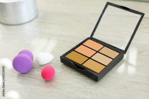 Palette with shadows and sponge on the table in the beauty salon photo