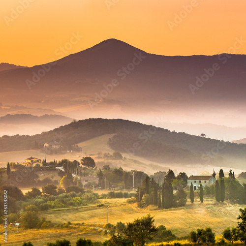 Sunrise over foggy Tuscany village