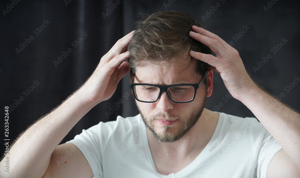 Man with a headache suffering from pain Man with a headache suffering from pain