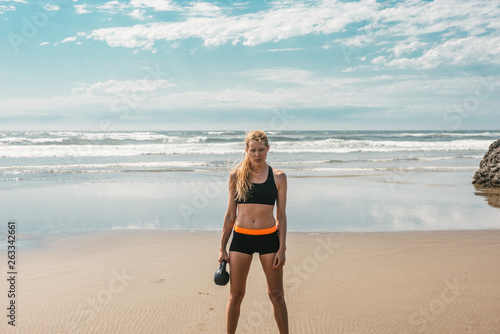 Woman working out on beach photo