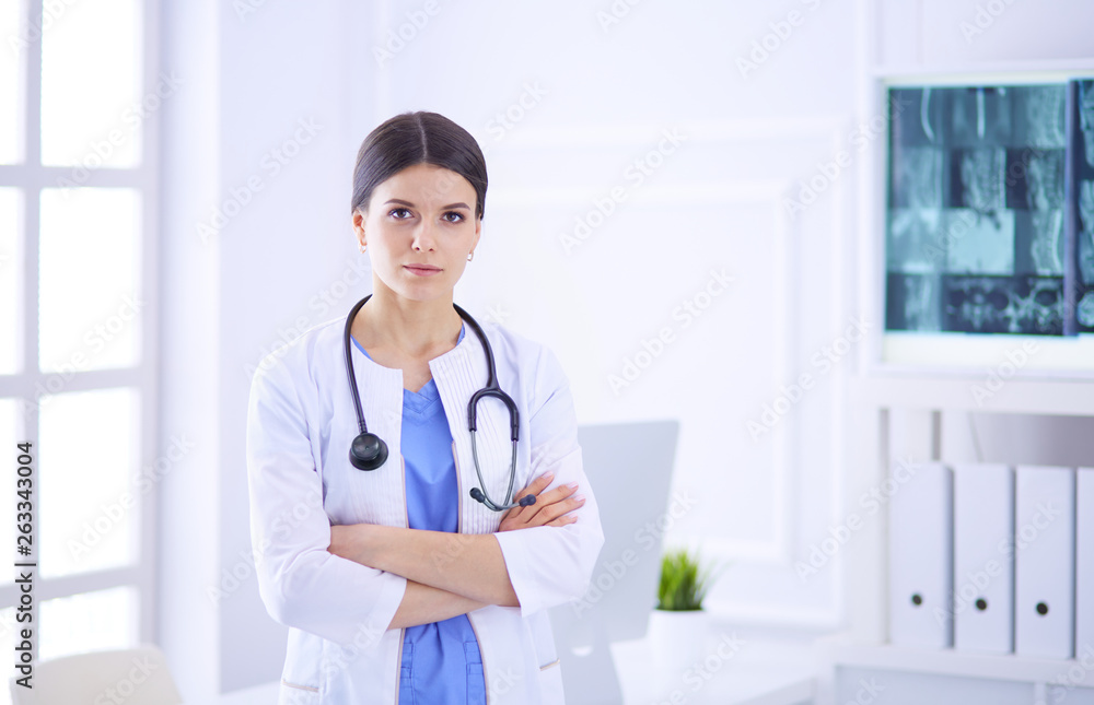 Young smiling female doctor with stethoscope at doctor's office Young smiling female doctor with stethoscope at doctor's office