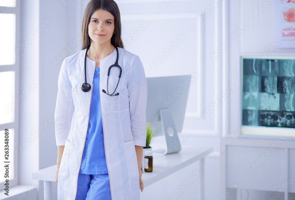 Female doctor standing at hospita with her stethoscope hanging on her neck Female doctor standing at hospita with her stethoscope hanging on her neck
