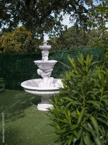 White fountain in the garden. 