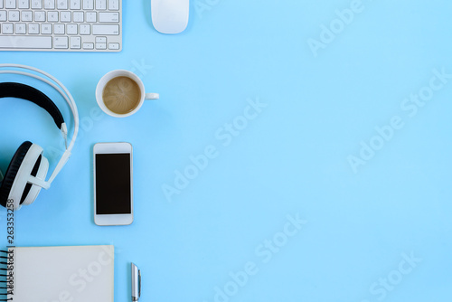 The office blue desk and equipment for working with coffee in top view and flat ray concept.