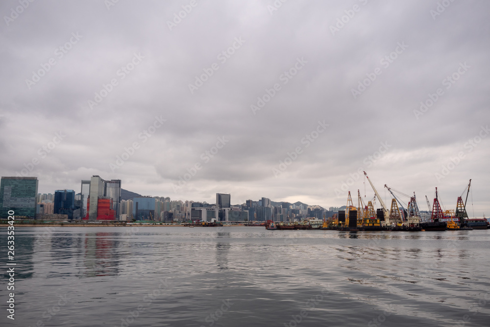 Panorama view of river, business district and crane boat on cloudy sky background and copy space