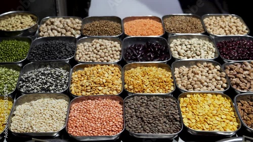 a panning shot of a variety of pulses for sale at the chandni chowk spice market in old delhi, india photo