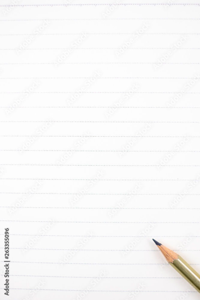 empty notebook and penceil on brown background, subject is blurred. empty notebook and penceil on brown background, subject is blurred.