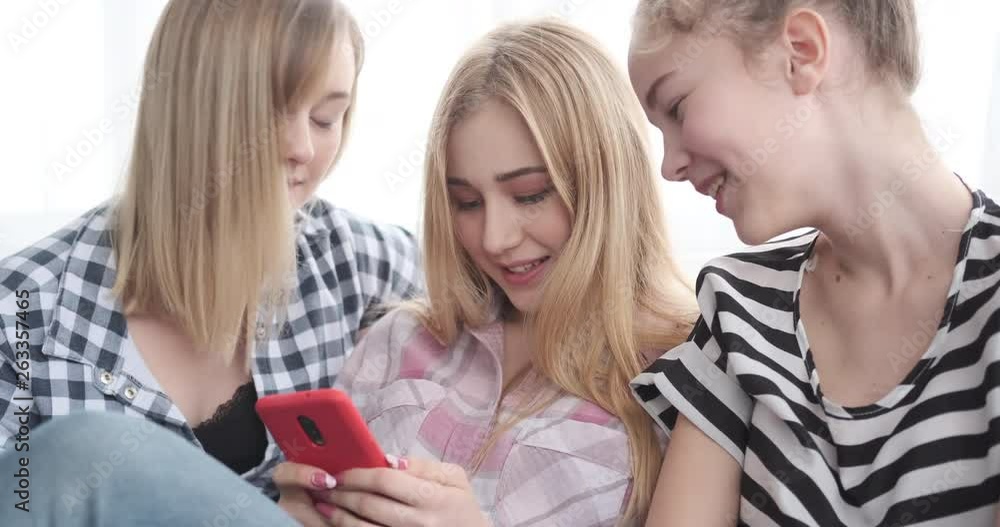 Teenage girls watching media content on smartphone Teenage girls watching media content on smartphone