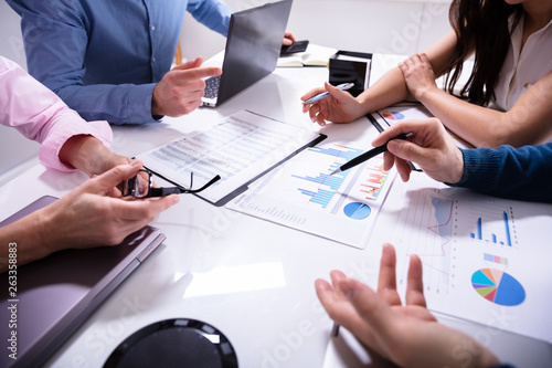 Business Colleagues Working Together With Data Analysis Paper photo