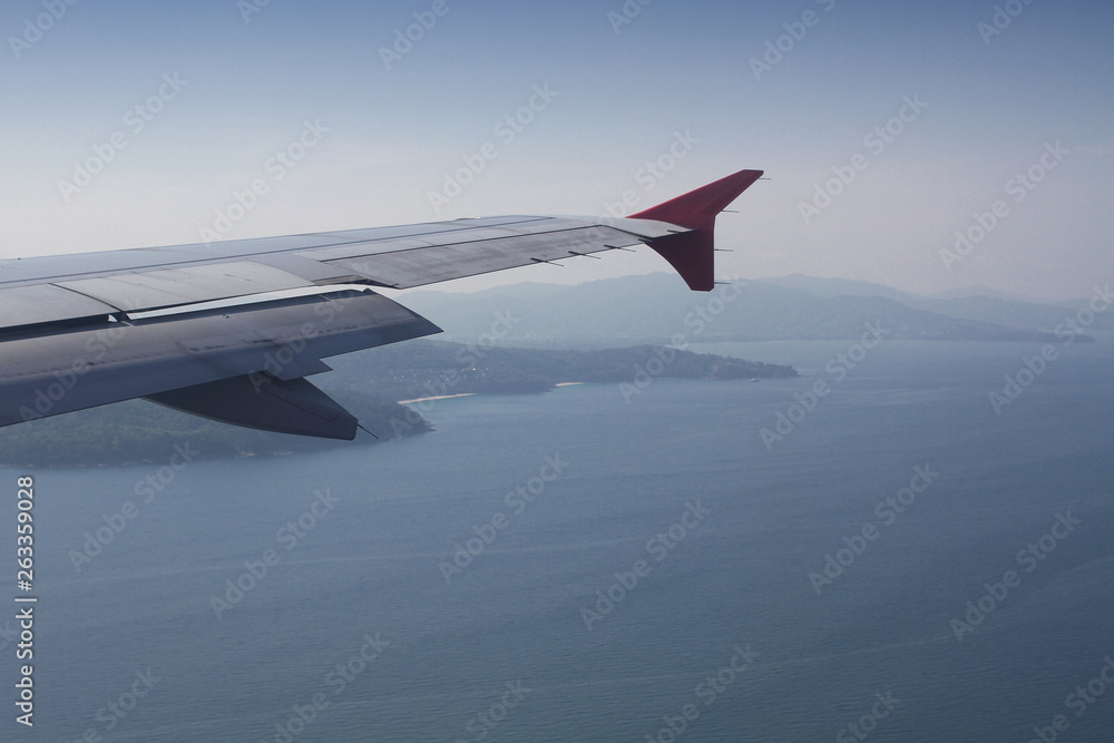 flying and traveling abroad, bird eye view from airplane window on the jet wing on wonderful island beach in vacation summer, journey backgrounds flying and traveling abroad, bird eye view from airplane window on the jet wing on wonderful island beach in vacation summer, journey backgrounds