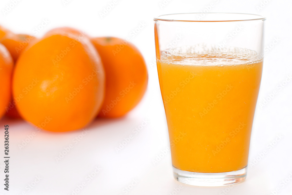 Glass of Fresh Orange Juice and Oranges on Isolated White Backdrop Glass of Fresh Orange Juice and Oranges on Isolated White Backdrop