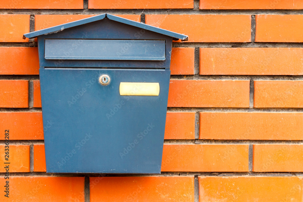 A beautiful mailbox hangs waiting for newspapers, parcels and letters.