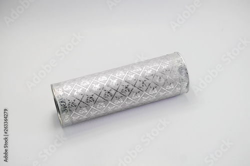 Metal cylinder with abstract pattern on white background
