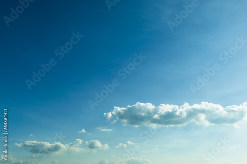 fluffy cloud above clear blue sky © sutichak
