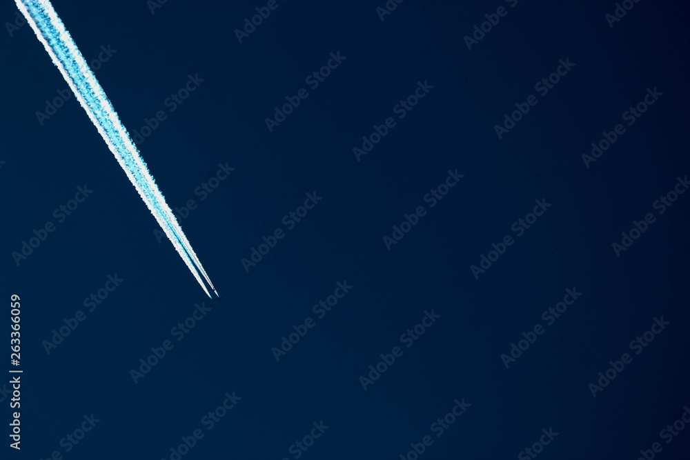 long-haul airplane in the evening sky with contrail long-haul airplane in the evening sky with contrail
