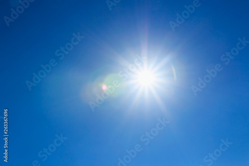 shining sun at clear on blue sky background with a copy space