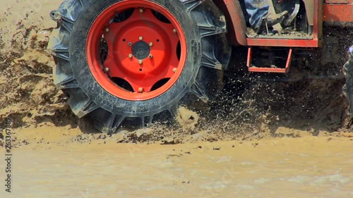 view footage drive tractor rides on an impassable mud, performance test, slow motion shot
