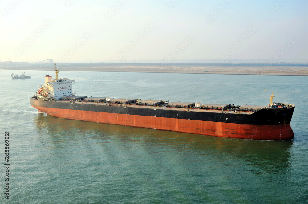Bulk carrier ship is leaving port. Bulk carrier ship is leaving port.
