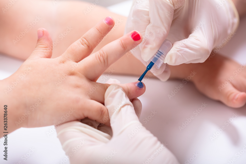 Beautician Applying Nail Polish To Girl's Nails Beautician Applying Nail Polish To Girl's Nails