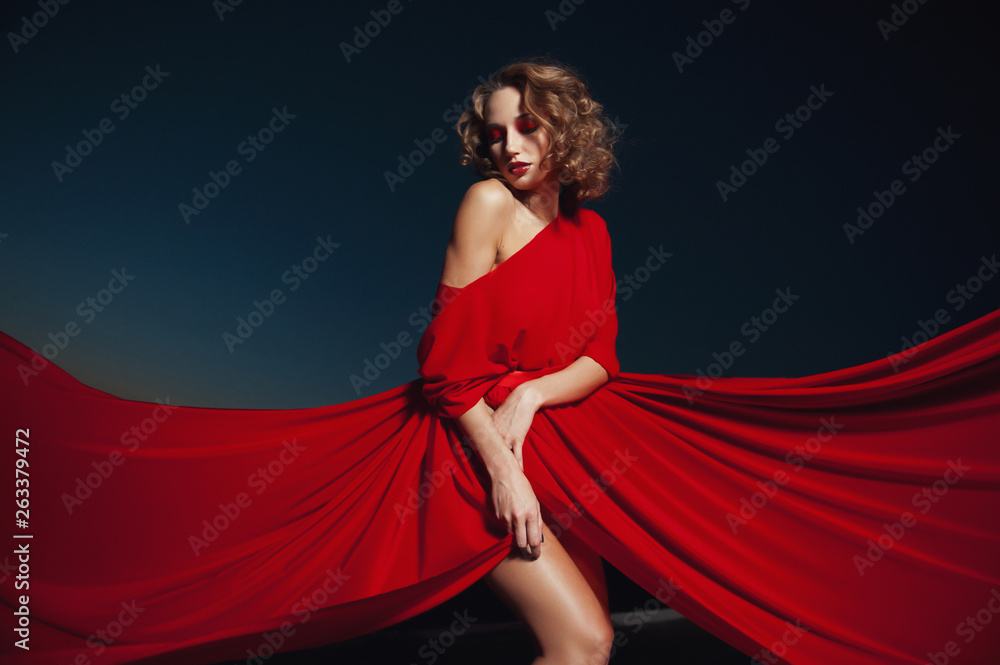 woman dancing in silk dress, artistic red blowing gown waving and flittering fabric woman dancing in silk dress, artistic red blowing gown waving and flittering fabric