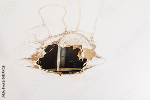 gypsum ceiling decay hole interior office building photo