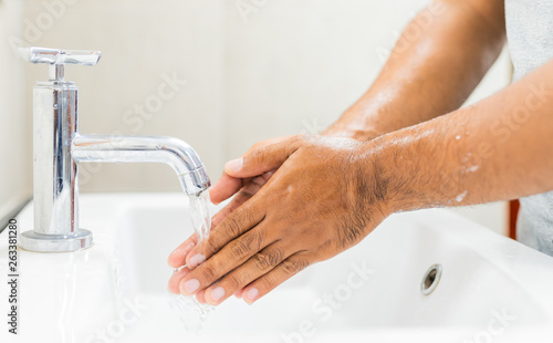 Man washing hands with soap.