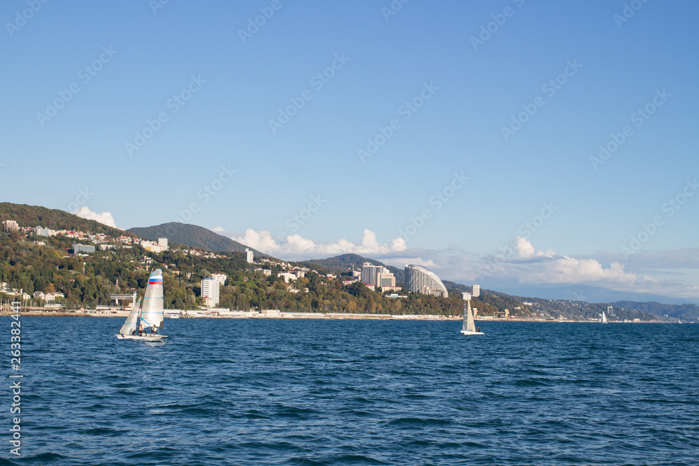 View of the city coast from the sea, sailboat