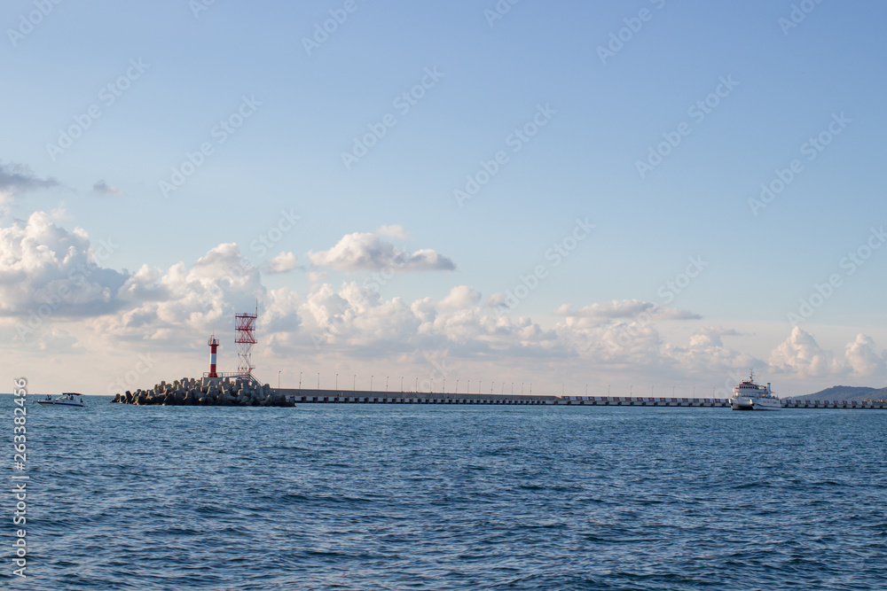 View of the city coast from the sea, lighthouse, ship View of the city coast from the sea, lighthouse, ship