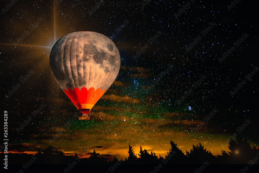 Colorful hot air balloon - moon rises very high in night starry sky ...