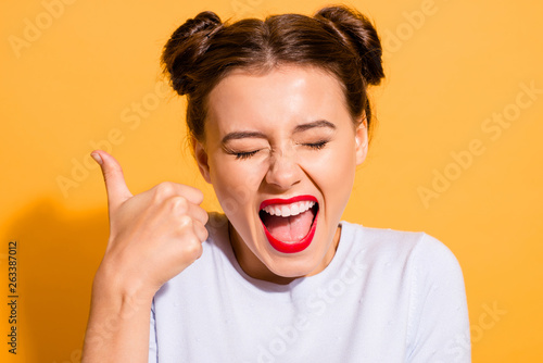 Close-up portrait of her she nice attractive winsome lovely cheerful cheery funny crazy optimistic girl showing thumbup ad advert excellent isolated over bright vivid shine yellow background