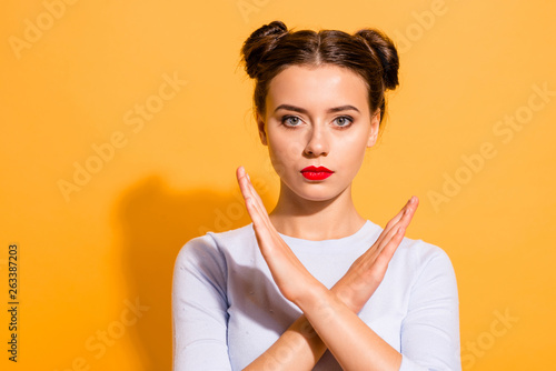 Close-up portrait of her she nice cute attractive lovely glamorous content decisive teen girl showing stop sign refuse deny decline offer crossed hands isolated on bright vivid shine yellow background photo