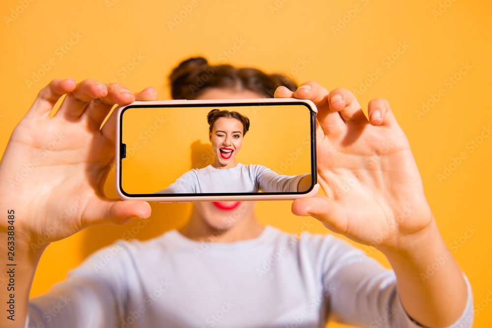 Bright memories. Close up photo of beautiful charming cute female student making photos videos downloading to web on vibrant background isolated in white clothing  