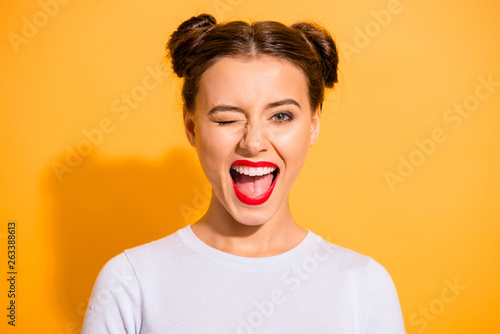 Fotografie Close up portrait of lovely cute funny lady making winks opening her mouth shout
