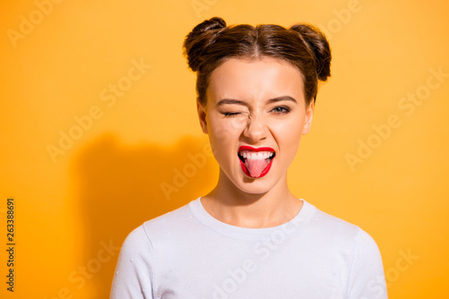 Close up portrait of magnificent upbeat lady college student with red lips pomade hanging out on parties dancing in night clubs screaming yeah in white light outfit isolated over vivid background © deagreez