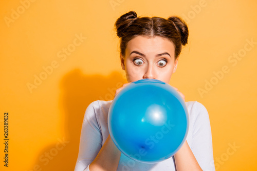 Close up photo of funky childish cheerful lady impressed by size of ballon for festivals carnivals celebration anniversary. Dressed in white cotton outfit isolated over vibrant background